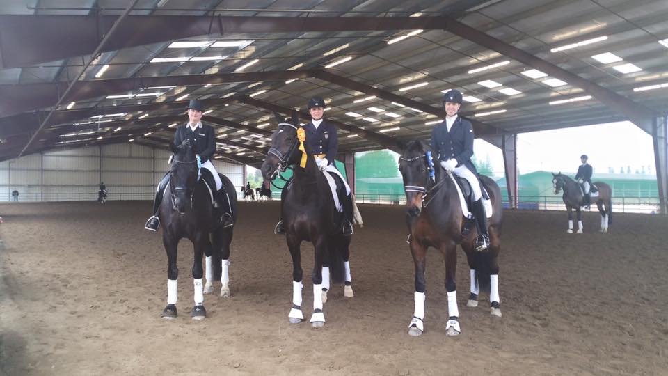 Three winning riders on their horses. 